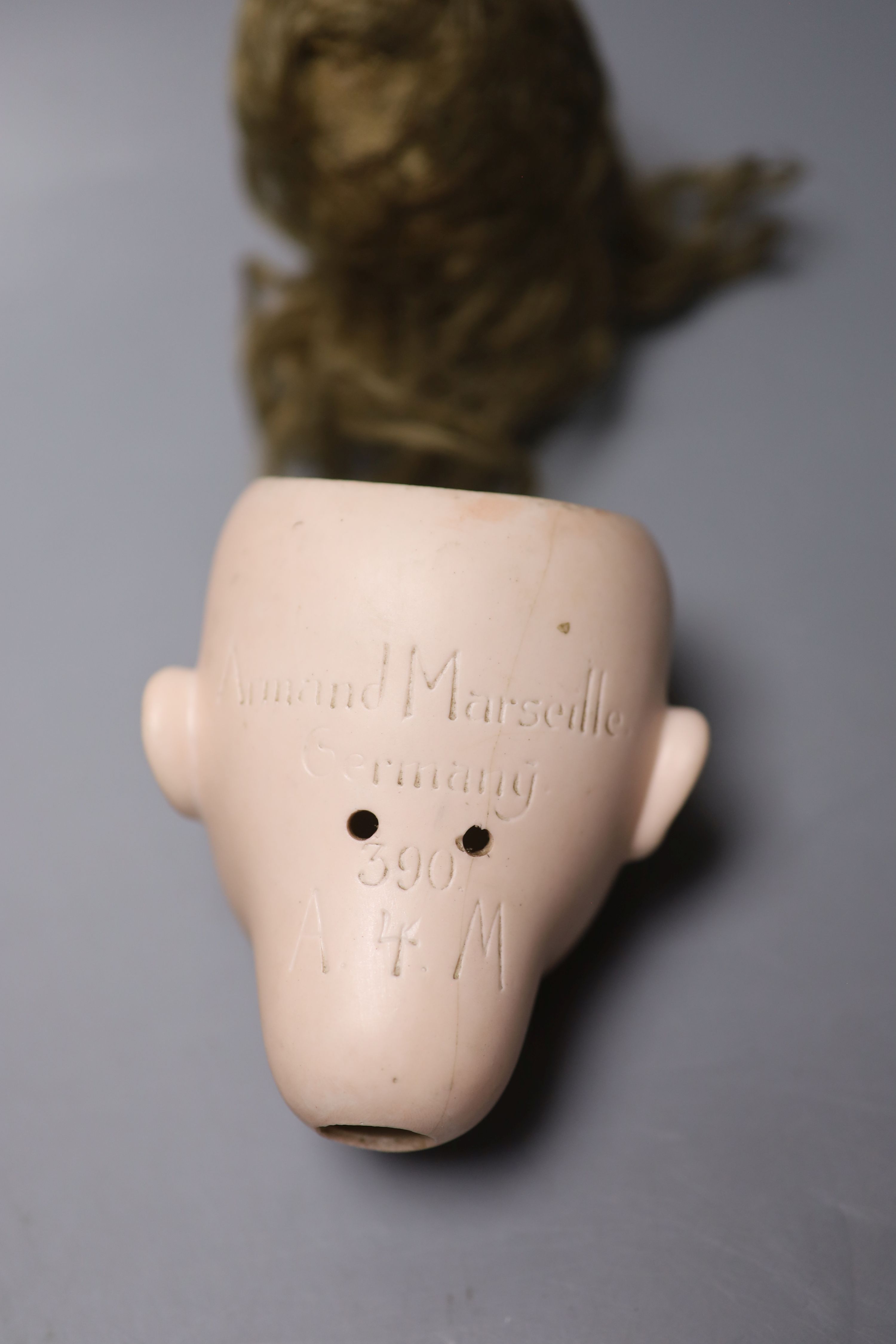 An Armand Marseille 390 bisque doll head, a Heubach Koppelsdorf bisque doll head and other